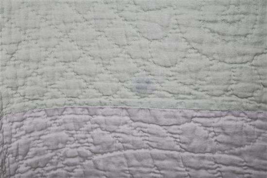 An off-white quilt with blue stitching, a reversible blue and cream quilt, a creamy oyster quilt and a mint green quilt (4)
